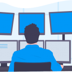 A man with a blue collard shirt and black hair looking into six monitors at his work desk.