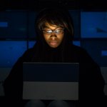 A focused developer coding on a laptop, illustrating the software development process.