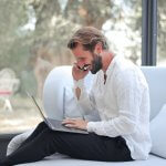 A developer’s workspace with multiple screens, representing multitasking in software development.