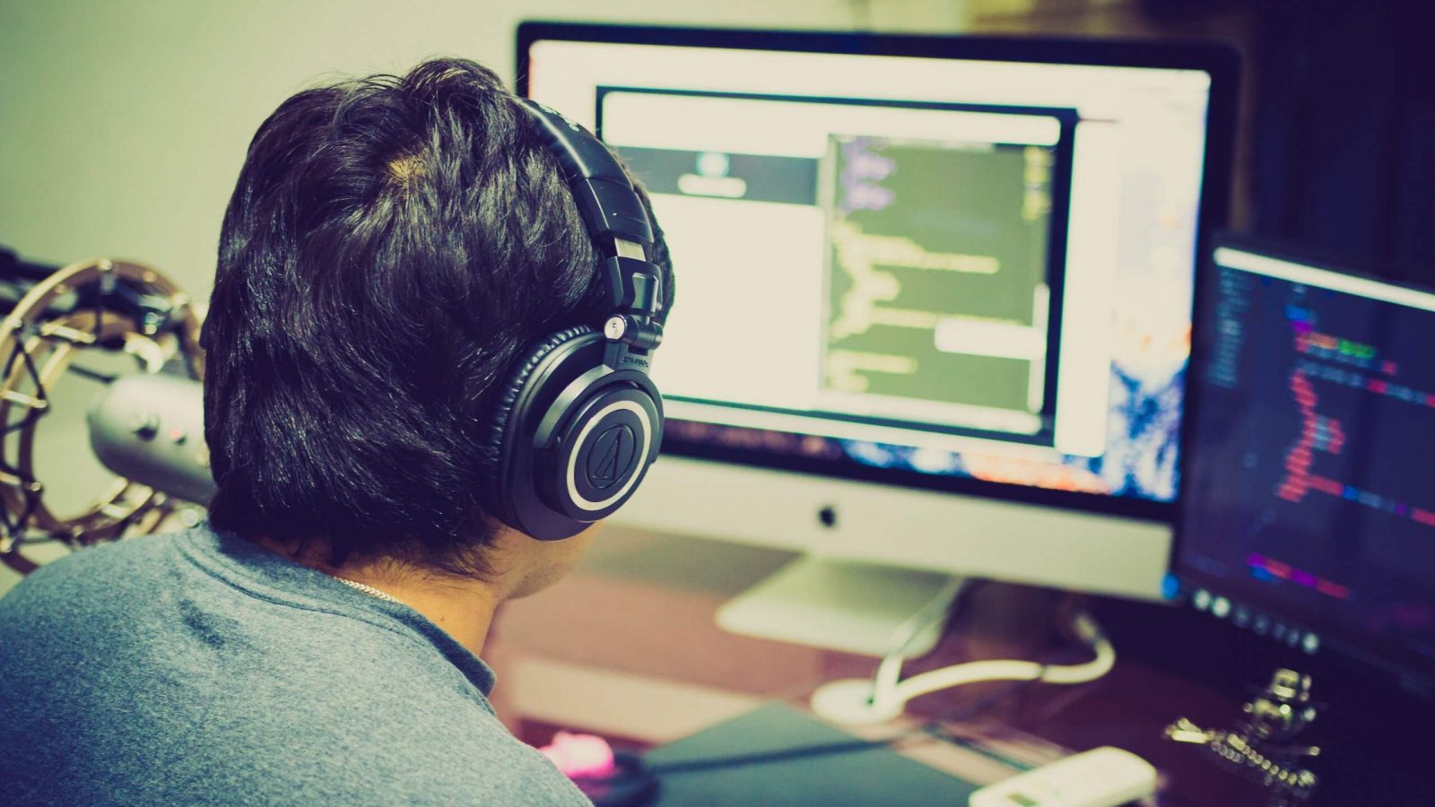 a person sitting at a desk in front of a computer