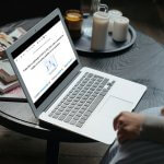 Laptop on a table displaying a Froala WYSIWYG HTML editor.