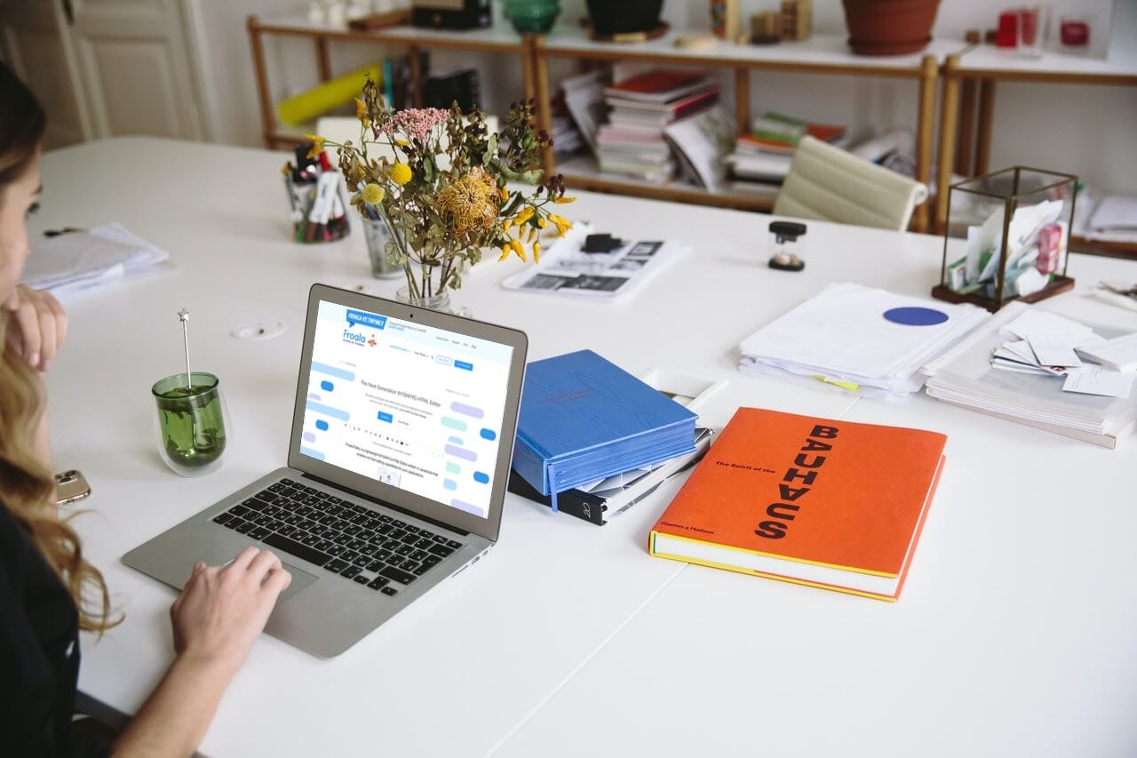 a group of people sitting at a table with a laptop