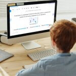 A person working on a computer with the Froala WYSIWYG HTML editor on the screen.