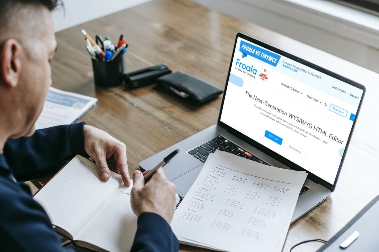 a man sitting at a desk with a laptop