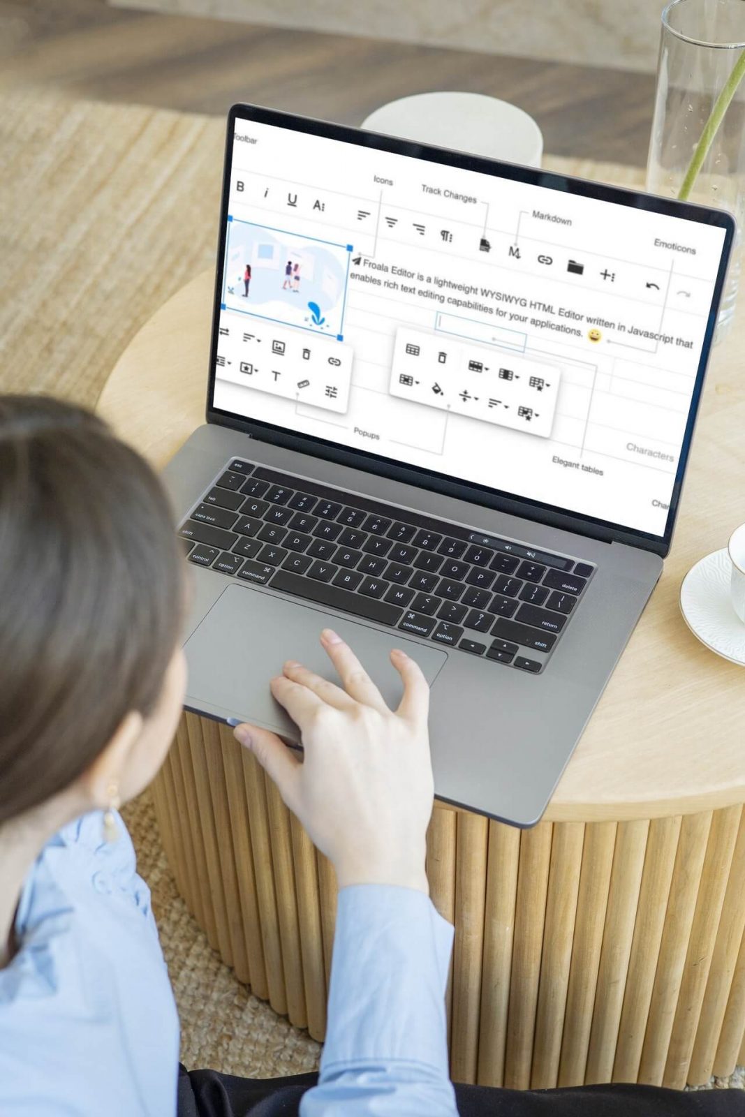 a person sitting at a table using a laptop