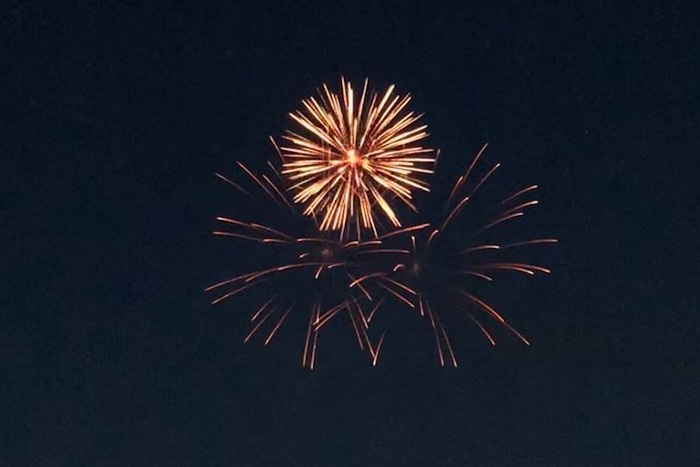 Some fireworks on a grainy night sky