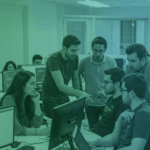 A team of web developers discussing the best HTML editors for professional workflows in a collaborative office environment.